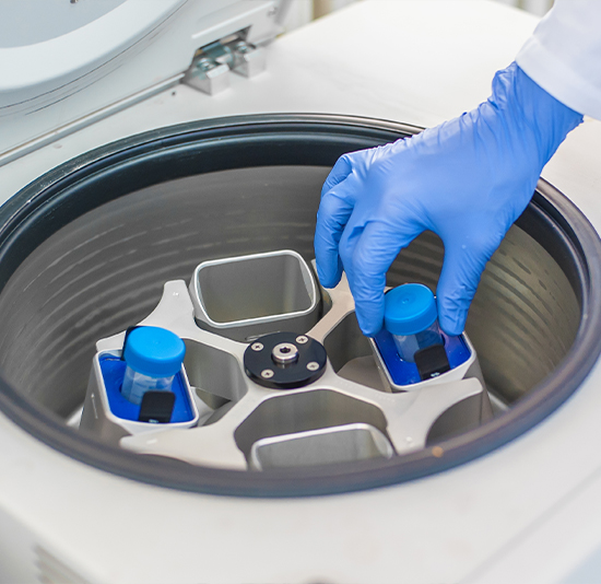 iStock-636481046 lab technician extracting samples from test tubes