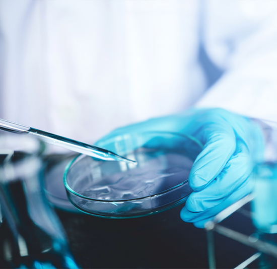iStock-962734944 lab technician extracting samples from test tubes
